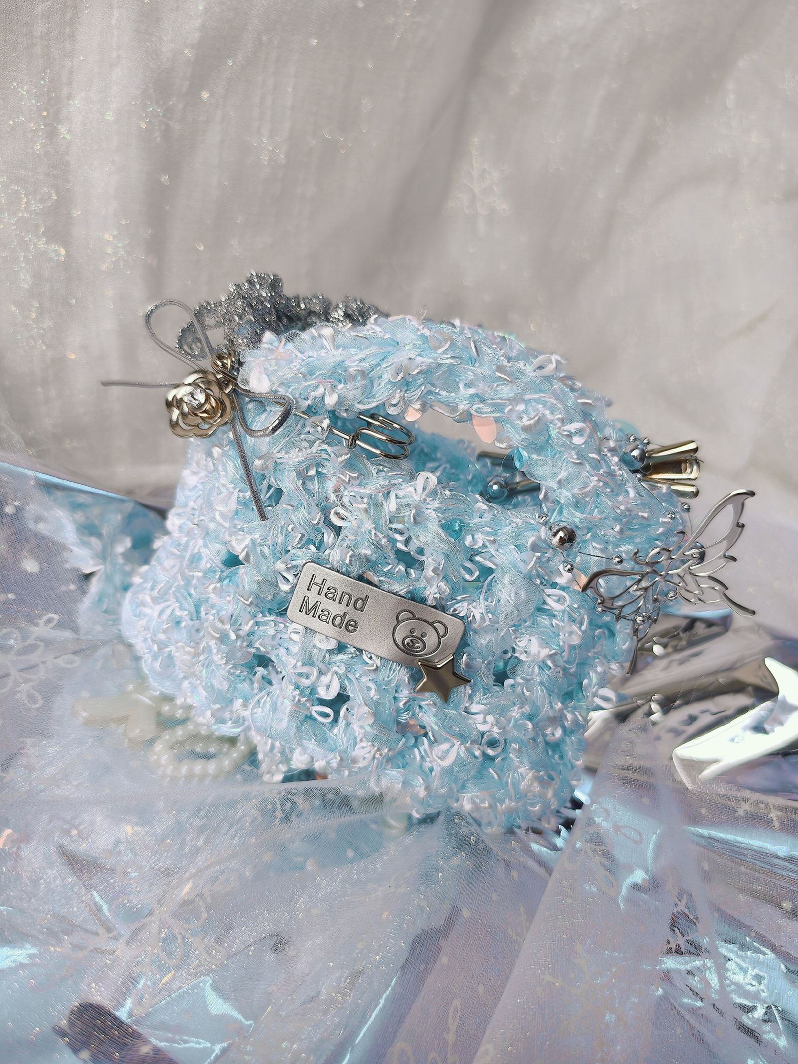 Close-up of iridescent blue art yarn with translucent fibers and shimmering textures