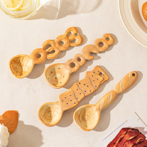 Cute ceramic spoon set with food-inspired designs arranged on a table