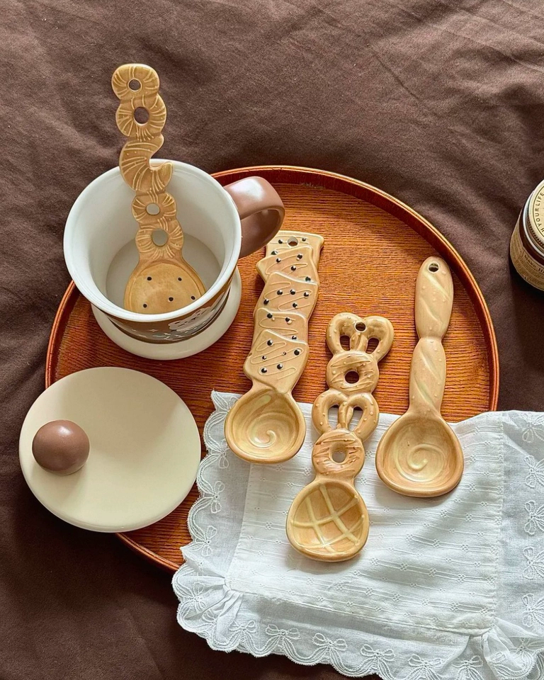 Cute ceramic spoon styled with coffee for a cozy breakfast setting