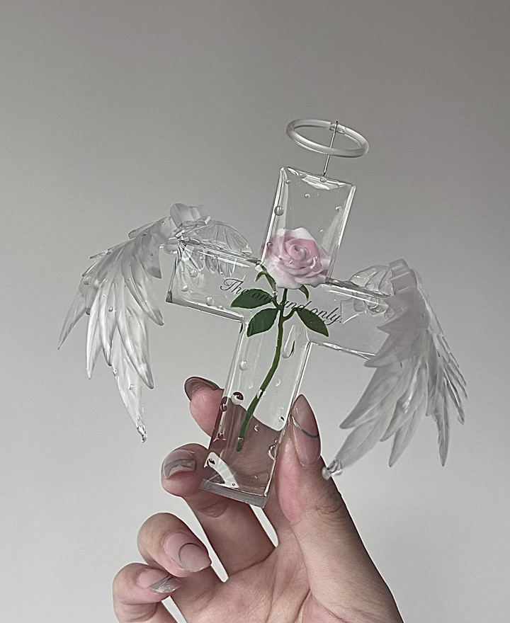 Finished clear resin cross with rose and angel wing details made using the mold