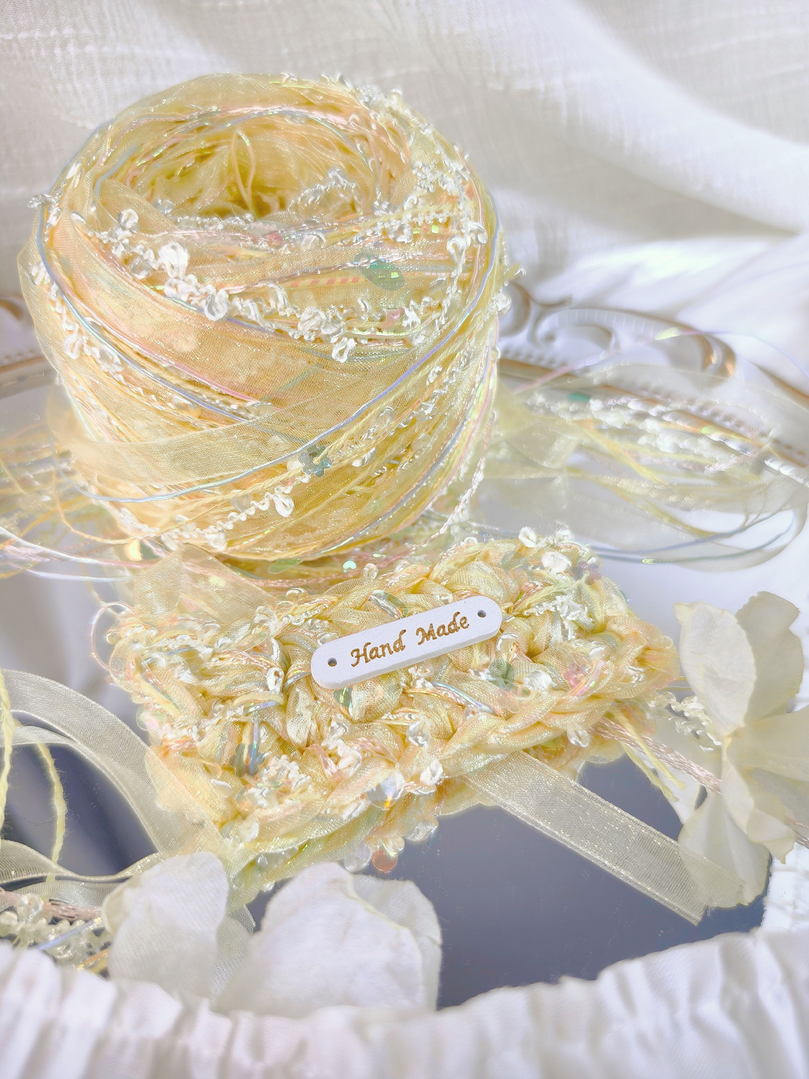 Handmade yellow textured art yarn ball with decorative fibers