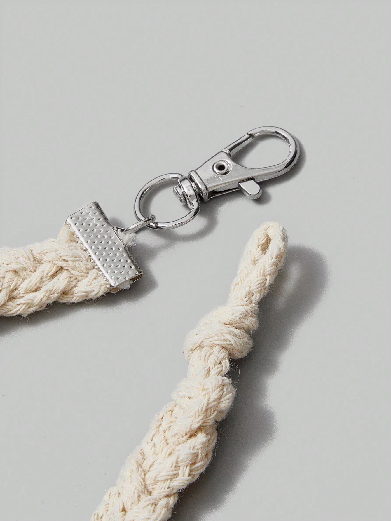 Sun necklace featuring layered silver-tone circular ring details around the pendant