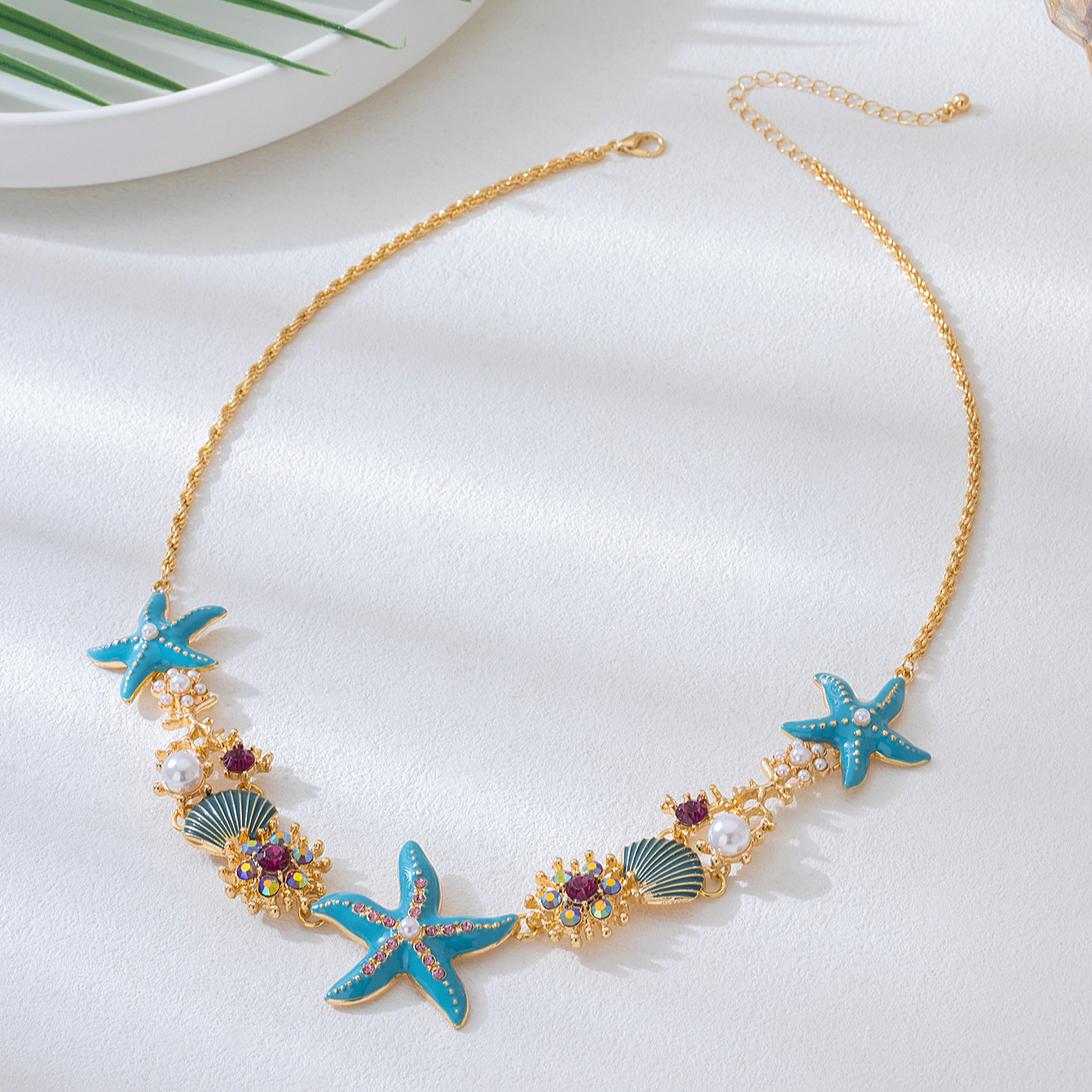 Ocean-inspired starfish necklace with turquoise starfish, seashells and pearl accents