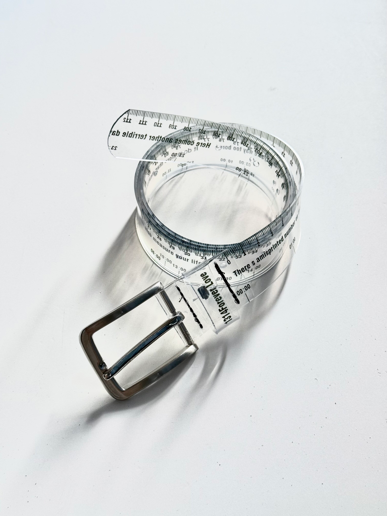 Metallic buckle detail on a transparent clear waist belt