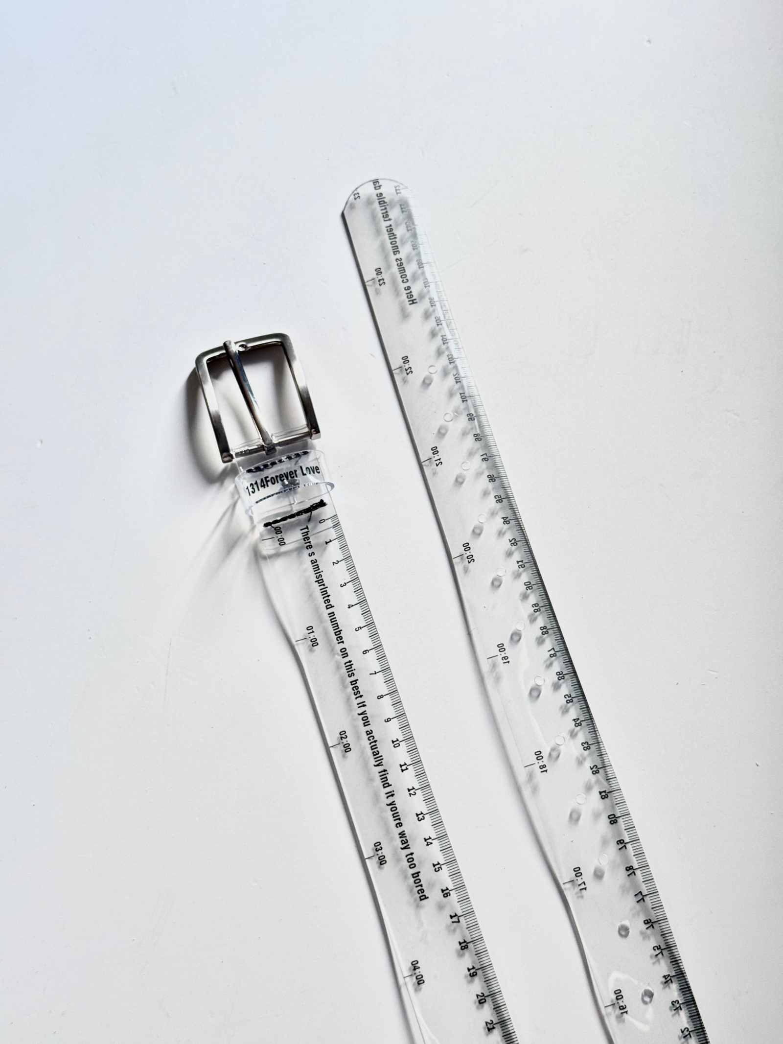 Close-up of printed ruler markings on a transparent fashion belt